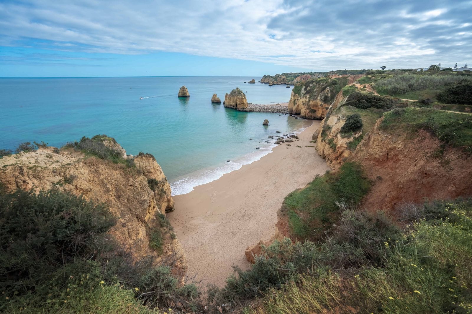 Praia do Pinhão beach cove with golden cliffs near Lagos, Algarve