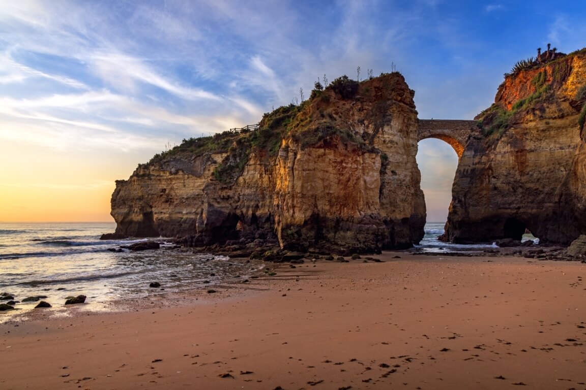 Stone bridge arch over the beach at Praia dos Estudantes, Lagos