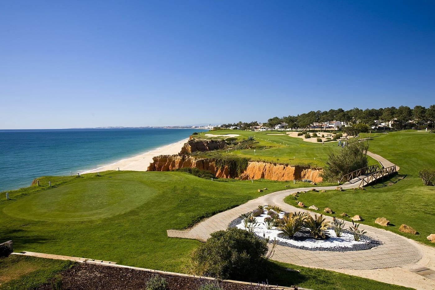 Vale do Lobo Royal Course par-3 16th hole with dramatic orange cliffs and Atlantic coastline